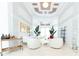 Bright sitting room with white furniture and large windows at 9210 Southern Breeze Dr, Orlando, FL 32836