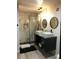 Sleek bathroom with a glass-enclosed shower and double vanity with contemporary fixtures and design at 1322 Seven Eagles Ct # 101, Reunion, FL 34747