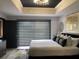 Modern bedroom with contemporary light fixture, blind-covered window, and sleek décor at 1322 Seven Eagles Ct # 101, Reunion, FL 34747