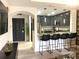 Modern kitchen with stainless steel appliances, gray cabinets, and breakfast bar seating at 1322 Seven Eagles Ct # 101, Reunion, FL 34747