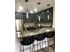 Modern kitchen with dark gray cabinets, granite countertops, and stainless steel appliances at 1322 Seven Eagles Ct # 101, Reunion, FL 34747