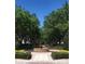 Beautiful garden with a fountain, lined by manicured hedges and mature trees at 1322 Seven Eagles Ct # 101, Reunion, FL 34747