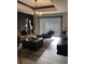 Well-lit living room featuring a brown sofa, artwork, and window blinds at 1322 Seven Eagles Ct # 101, Reunion, FL 34747