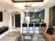 Modern living room featuring a bar, stainless steel appliances, and stylish decor at 1322 Seven Eagles Ct # 101, Reunion, FL 34747