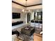 Open-concept living area with a sleek TV, kitchen bar, and contemporary furnishings at 1322 Seven Eagles Ct # 101, Reunion, FL 34747