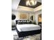 Sophisticated main bedroom with an arched entrance and stylish decorations at 1322 Seven Eagles Ct # 101, Reunion, FL 34747