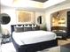 Elegant primary bedroom features a luxurious bed and stylish decor at 1322 Seven Eagles Ct # 101, Reunion, FL 34747
