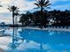 Large outdoor swimming pool with lounge chairs and palm trees, perfect for relaxation at 1322 Seven Eagles Ct # 101, Reunion, FL 34747
