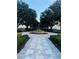 Scenic walkway leading to a fountain, lined with trees and manicured hedges at 1322 Seven Eagles Ct # 101, Reunion, FL 34747