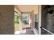 Covered front porch featuring tile floor, stucco walls and an open view into the front yard at 5317 Micco St, Kissimmee, FL 34746