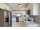 Bright kitchen featuring white cabinets, stainless steel appliances, and granite countertops at 5317 Micco St, Kissimmee, FL 34746
