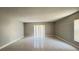 Bright living room with tiled floor and sliding glass door at 5317 Micco St, Kissimmee, FL 34746