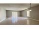 Open living room with tiled flooring and sliding glass door to the outside at 5317 Micco St, Kissimmee, FL 34746