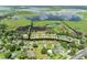 Wide aerial shot of the neighborhood, with a canal running behind the houses and leading to a large lake at 720 Shore Drive, Kissimmee, FL 34744