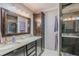 Bathroom features double sinks, granite countertops, a dark wood cabinet, and a glass enclosed shower for a luxurious experience at 720 Shore Drive, Kissimmee, FL 34744