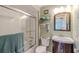 Bathroom features a shower-tub combo with glass doors and a wooden vanity, providing a functional and stylish space at 720 Shore Drive, Kissimmee, FL 34744