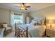 Light and airy bedroom with decorative bedding, neutral walls and a ceiling fan at 720 Shore Drive, Kissimmee, FL 34744