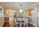 Charming dining area with hardwood floors and decorative chandelier at 720 Shore Drive, Kissimmee, FL 34744