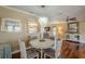 Dining room features wood floors, an elegant chandelier, and views into the living room at 720 Shore Drive, Kissimmee, FL 34744