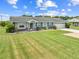 Charming single story home with a well manicured lawn at 720 Shore Drive, Kissimmee, FL 34744