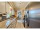 Updated kitchen with stainless steel appliances and granite countertops at 720 Shore Drive, Kissimmee, FL 34744
