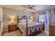 Comfortable main bedroom featuring an ornate bed frame, decorative bedding, and wood nightstands at 720 Shore Drive, Kissimmee, FL 34744
