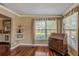 Cozy office with hardwood floors, shelving, and a large window at 720 Shore Drive, Kissimmee, FL 34744