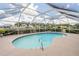 Screened-in pool area with a sparkling blue pool surrounded by a concrete patio, offering a refreshing outdoor space at 720 Shore Drive, Kissimmee, FL 34744