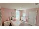 Charming bedroom with light pink walls and white furniture at 1401 Hollow Creek Ln, Kissimmee, FL 34744