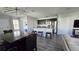 Open concept kitchen and dining area with island and modern lighting at 1401 Hollow Creek Ln, Kissimmee, FL 34744