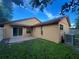 The backyard features a concrete patio with sliding glass doors leading inside, green grass, and an AC unit at 3180 Owassa Ct, Kissimmee, FL 34746