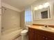 Traditional bathroom featuring a bathtub and vanity with a framed mirror at 3180 Owassa Ct, Kissimmee, FL 34746