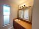 Bright bathroom vanity with framed mirror, sink and window with natural light at 3180 Owassa Ct, Kissimmee, FL 34746