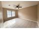 Cozy bedroom features tile flooring, ceiling fan, and a bright window at 3180 Owassa Ct, Kissimmee, FL 34746