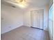 Bright bedroom with tile flooring, ceiling fan, window, and closet at 3180 Owassa Ct, Kissimmee, FL 34746