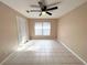Cozy bedroom features tile flooring, ceiling fan, and a bright window at 3180 Owassa Ct, Kissimmee, FL 34746