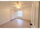 Bright bedroom with tile flooring, ceiling fan, window, and closet at 3180 Owassa Ct, Kissimmee, FL 34746
