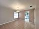 This dining room boasts tile flooring and an adjacent doorway that leads to the kitchen at 3180 Owassa Ct, Kissimmee, FL 34746