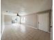 Bright living room features neutral paint, tile floors, and a ceiling fan, creating a welcoming atmosphere at 3180 Owassa Ct, Kissimmee, FL 34746