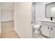 Contemporary bathroom with a modern vanity, marble tile, and a sleek mirror at 4401 Marshall St, Orlando, FL 32811