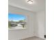 Simple bedroom with wood-look flooring and a large window offering natural light at 4401 Marshall St, Orlando, FL 32811