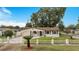 Charming ranch house with a manicured lawn and white fence at 4401 Marshall St, Orlando, FL 32811