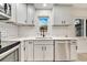 Renovated kitchen with white cabinets, quartz countertops, subway tile backsplash, and stainless steel appliances at 4401 Marshall St, Orlando, FL 32811