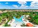 An aerial view of the community lazy river surrounded by mature landscaping at 6012 Oak Green Loop, Davenport, FL 33837