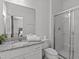 Bathroom featuring a granite countertop, white cabinets, and a glass-enclosed shower at 6012 Oak Green Loop, Davenport, FL 33837