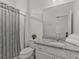 Bathroom featuring a granite countertop, white cabinets, and a shower with a patterned curtain at 6012 Oak Green Loop, Davenport, FL 33837