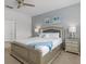 Inviting bedroom featuring a luxurious bed with silver frame, matching nightstands, and soft lighting at 6012 Oak Green Loop, Davenport, FL 33837