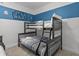 A bedroom features a bunk bed and fun Star Wars themed wall decor at 6012 Oak Green Loop, Davenport, FL 33837