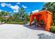 Poolside cabana with seating for outdoor entertaining, surrounded by mature landscaping at 6012 Oak Green Loop, Davenport, FL 33837