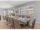 Dining room with large table, seating for ten, and bright window with sun-blocking blinds at 6012 Oak Green Loop, Davenport, FL 33837